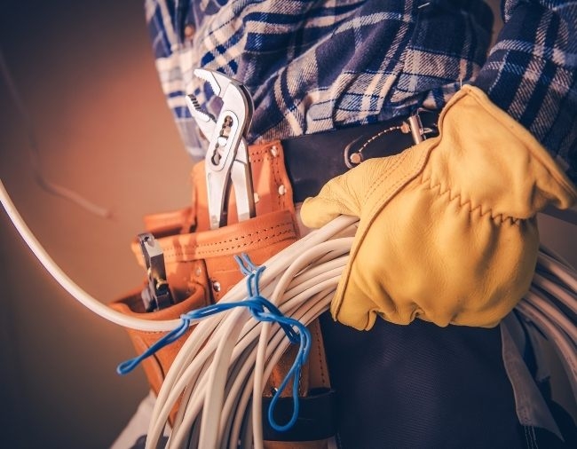 Electrician holding wires