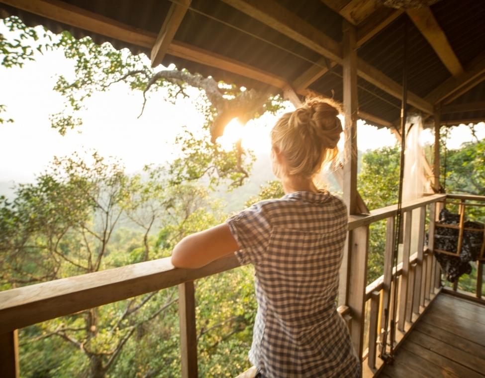 Female Looking at Sunset on porch