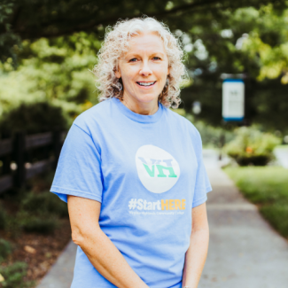 Portrait of Karen Kilgore, a woman with curly blonde hair, wearing a light blue Virginia Highlands Community College t-shirt.