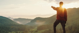 Male pointing at Sunset