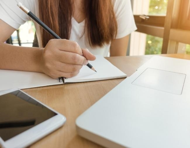 Girl Writing at Desk